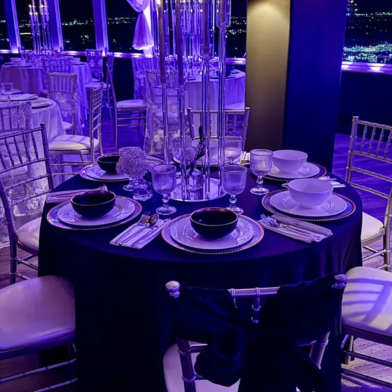 Acrylic candelabra with LED tapers against the night skyline