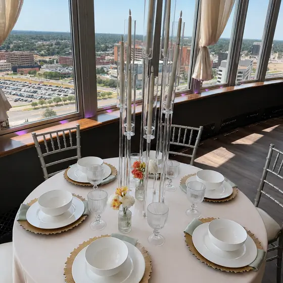 Champagne linen and gold sunburst chargers overlooking the city